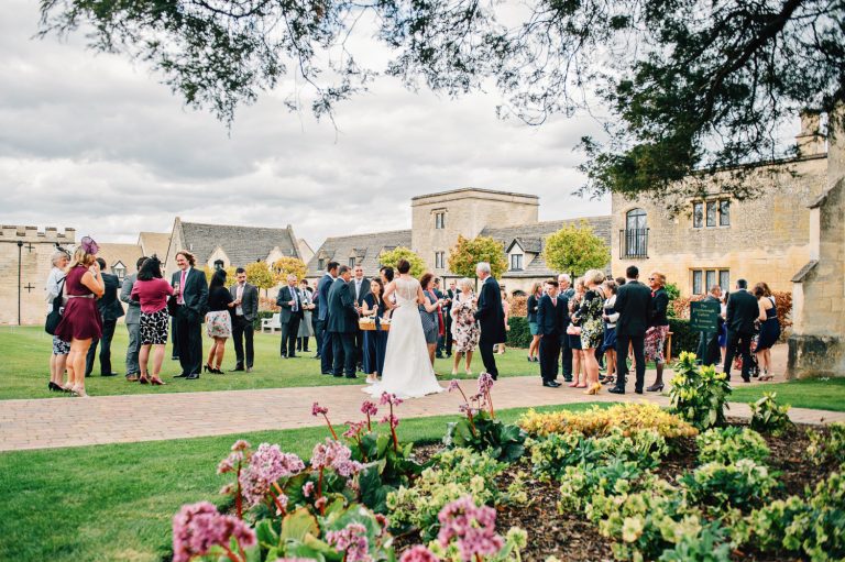 Guests relax on the lawns at Ellenborough Park during a wedding.