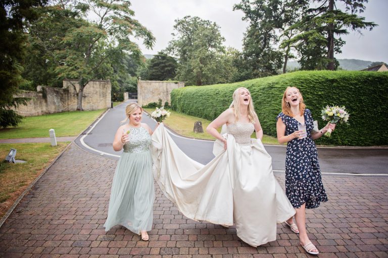 Laughing bride and her bridesmaids at a wedding at Ellenborough Park.