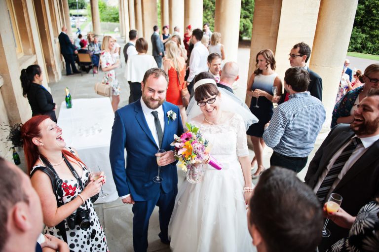 Candid photo of wedding guests chatting at Pittville Pump Room wedding.