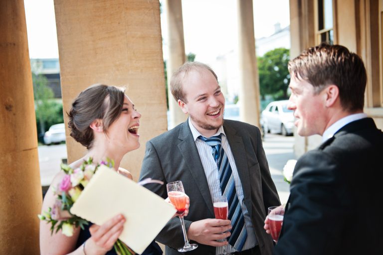 Candid photo of wedding guests laughing.