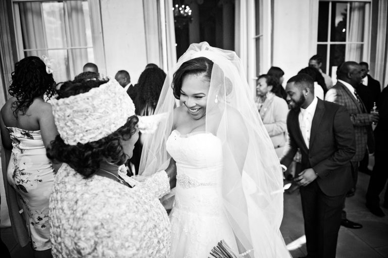 Candid, documentary photo of bride being congratulated by her aunt.