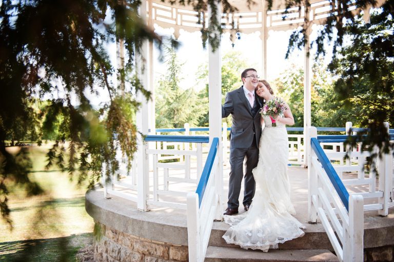 Bride and groom grab a moment together by the Pittville Band Stand.