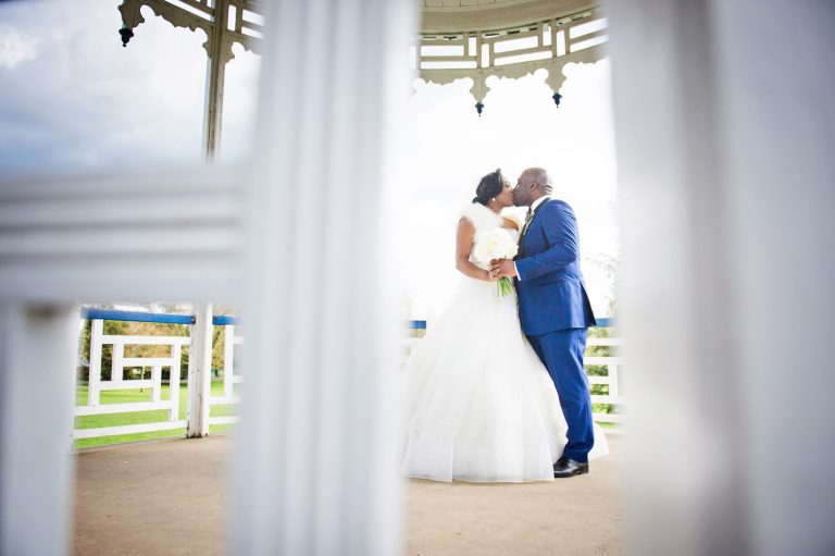 Bride and groom kiss on the bandstand at Pittville Pump Rooms.