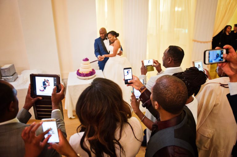 Bride and groom cut their wedding cake at the Pittville Pump Rooms.
