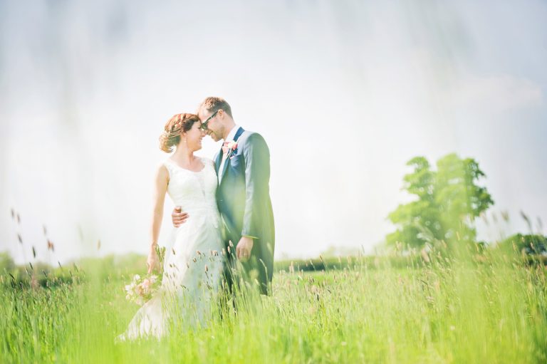 Bride and groom photo in field at Priston Mill.