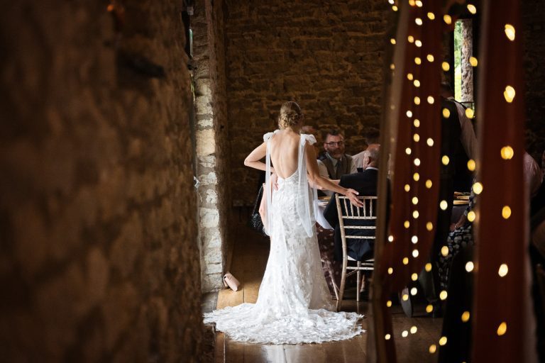 Brides wedding dress lit by sparkly lights at Priston Mill.