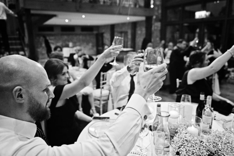 Raising a glass at the end of wedding speeches at Priston Mill.