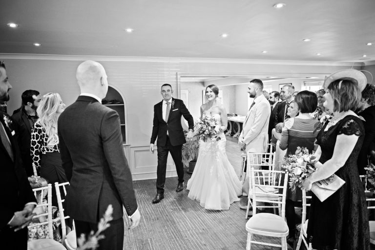 Bride enters the ceremony room with her father at The Slaughters Country Inn