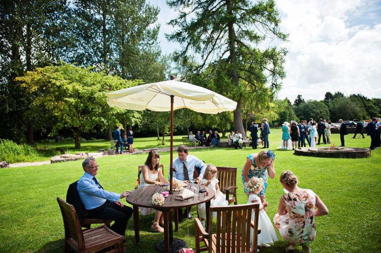 Wedding guests relax in the grounds at The Slaughters Country Inn
