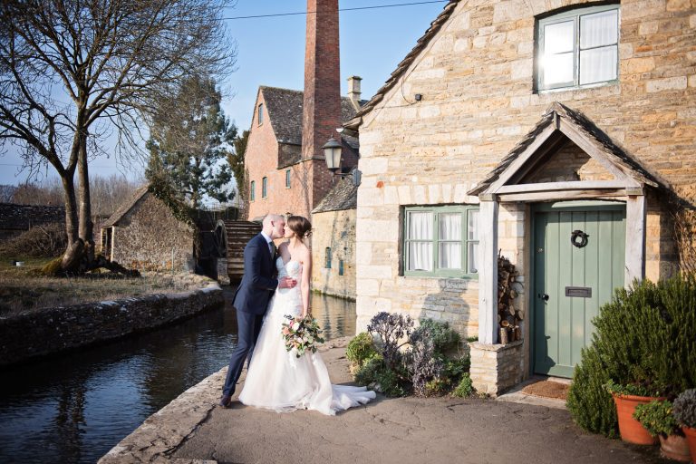 Bride and groom at their wedding at Lower Slaughter by the Infamous Mill.