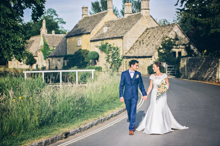 Bride and groom candidly chat at The Slaughters Country Inn in Lower Slaughter.