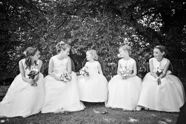 Flower girls sitting down. B&W photo.