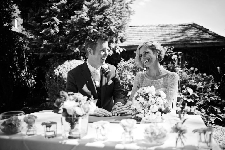Bride and groom smiling after signing the register.