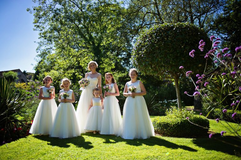 Bride and the flower girls in the gardens at The Swan Hotel, Bibury.