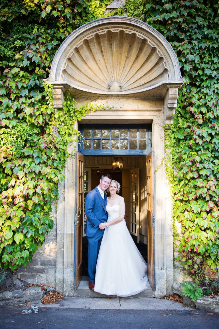 Portrait photo of bride and groom outside The Swan, Bibury.