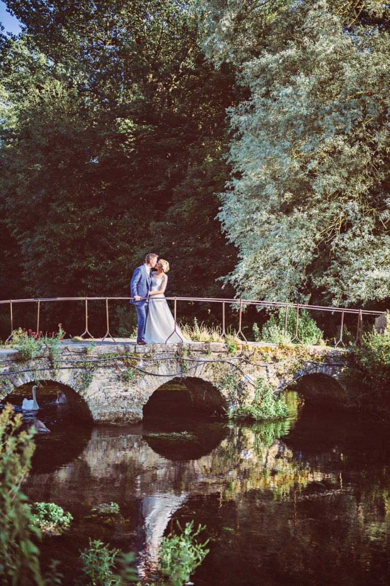 Bride and groom on the bridge in Bibury, near Arlington Row.