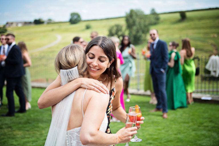 Congratulations friend hugging the bride.