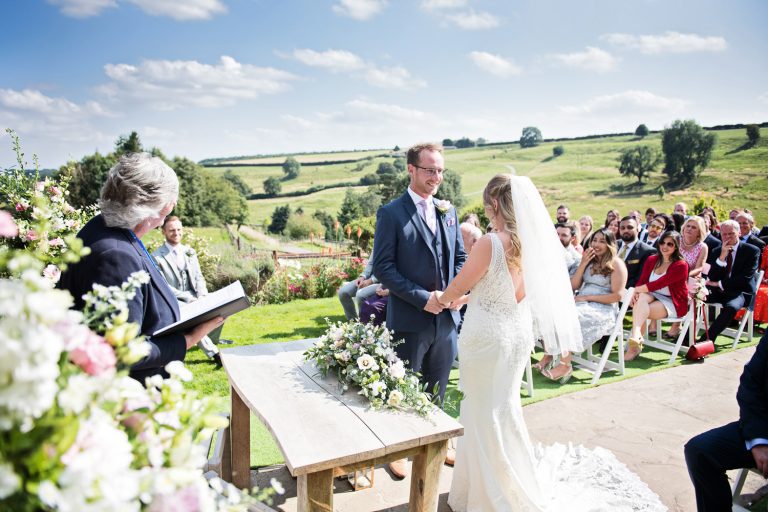 Candid image of an outdoor ceremony taking place at Kingscote Barn.