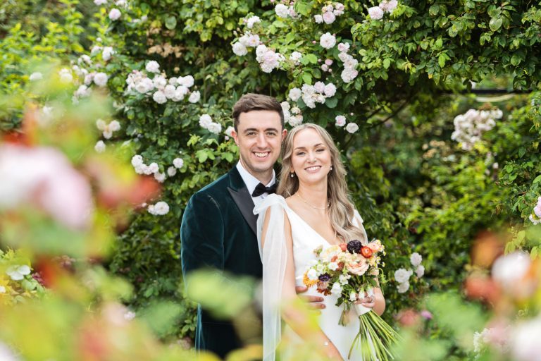 Bride and groom in the rose garden