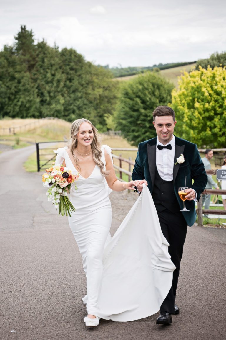 Bride and groom on the drive at Kingscote Barn.