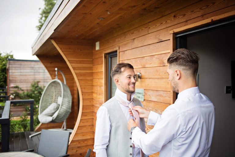 Groomsmen get ready for a wedding at Kingscote Barn.