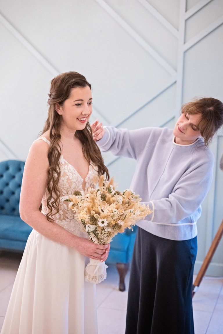 Bride having final touch ups in the bridal suite at Kingscote Barn.