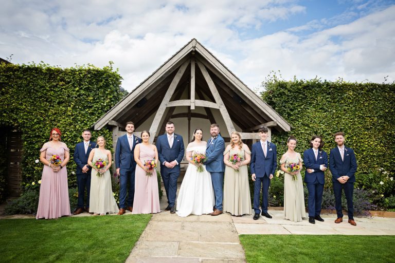 Relaxed group photo of bridal party at Kingscote Barn.