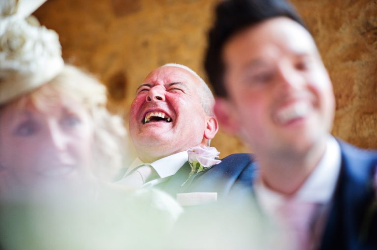 Wedding guest laughing.