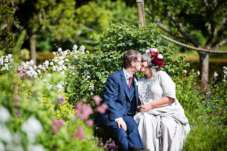 Bride and groom grab a moment together at the Rococo Gardens, Painswick.