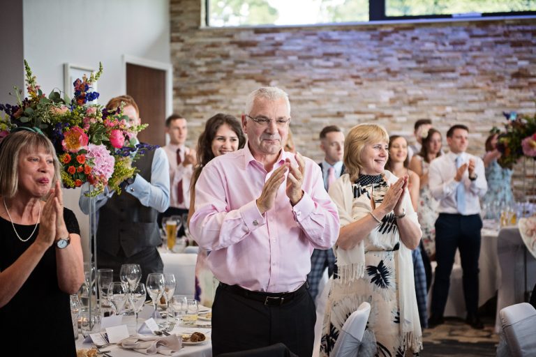 Documentary photo of wedding guests at Tewkesbury Park in the Cotswold Suite.