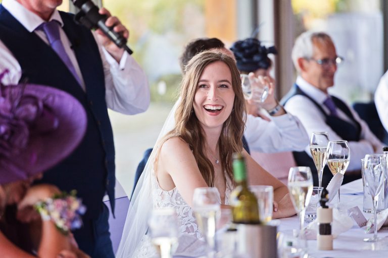 Documentary photo of bride during wedding speeches at Tewkesbury Park in the Cotswold Suite.