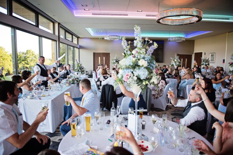 Documentary photo of wedding guests at Tewkesbury Park in the Cotswold Suite.