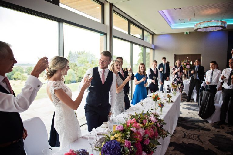 Candid photo of wedding guests at Tewkesbury Park in the Cotswold Suite.
