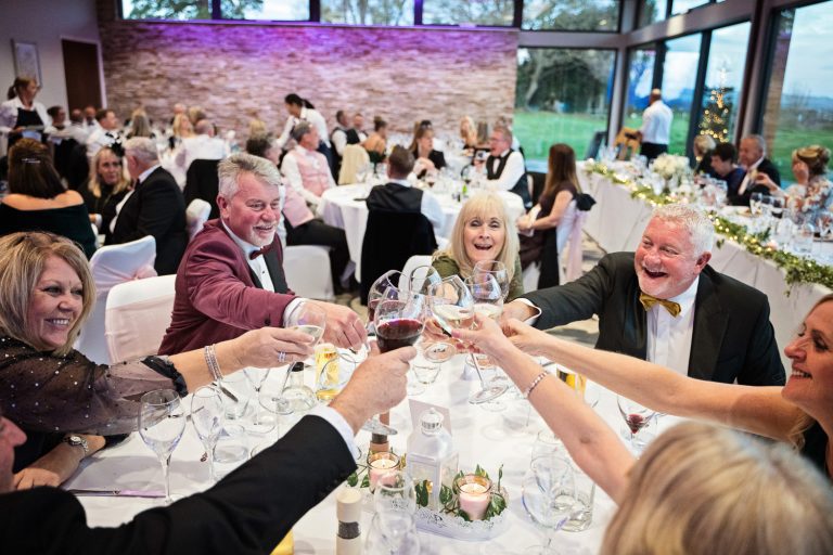 Documentary photo of wedding guests at Tewkesbury Park in the Cotswold Suite.
