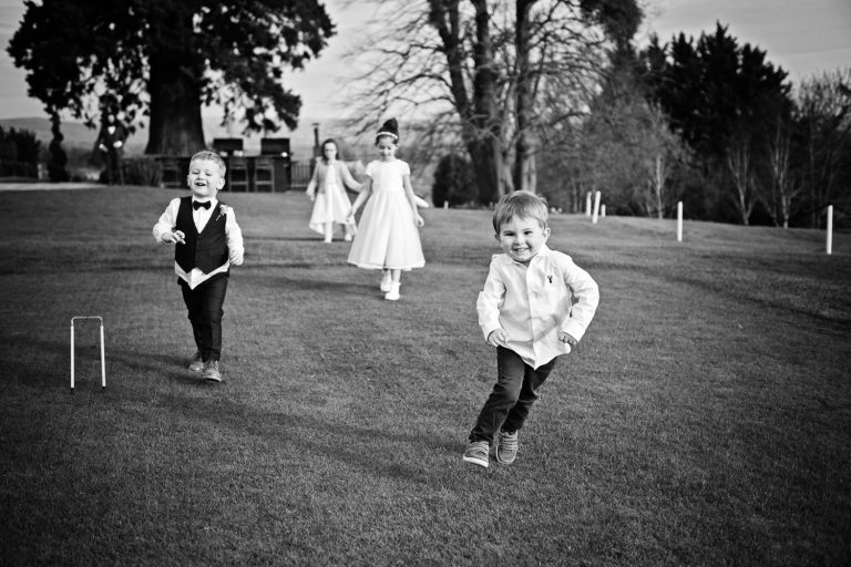 Story telling image of wedding guests playing at Tewkesbury Park