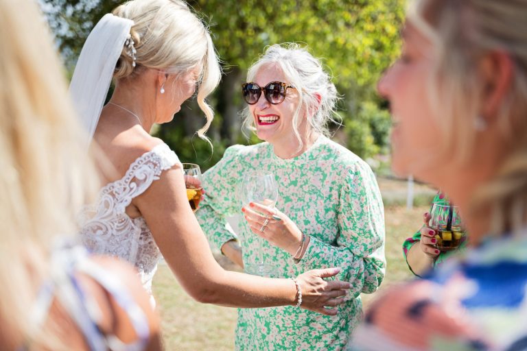 Story telling image of wedding guests congratulating the bride at Tewkesbury Park