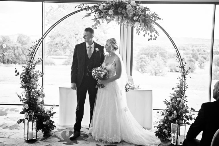 B&W photo of a bride and groom at a wedding in the Cotswold Suite at Tewkesbury Park