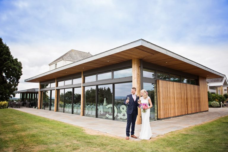 Bride and groom in front of the Cotswold Suite at Tewkesbury Park.