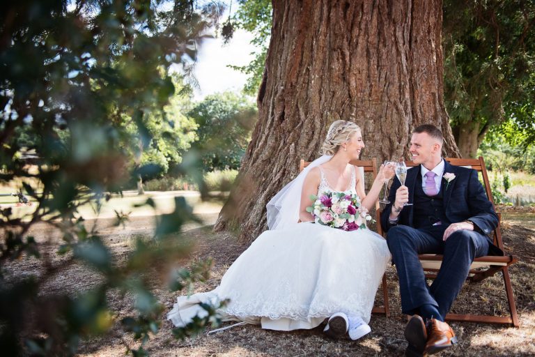 Bride and groom grab a moment in the grounds at Tewkesbury Park.