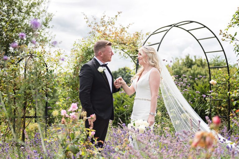 Bride and groom grab a moment in the grounds at Tewkesbury Park.