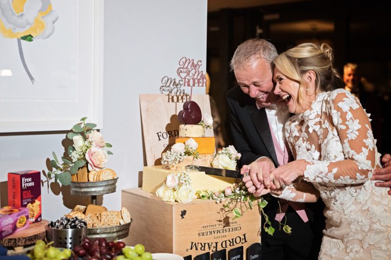 Bride and groom cut their wedding cheese cake at Tewkesbury Park