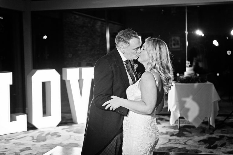 Bride and groom kiss during their first dance at Tewkesbury Park