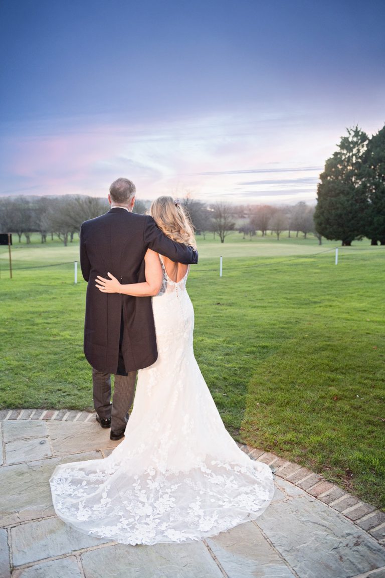 Bride and groom grab a moment and watch the sunset at Tewkesbury Park.