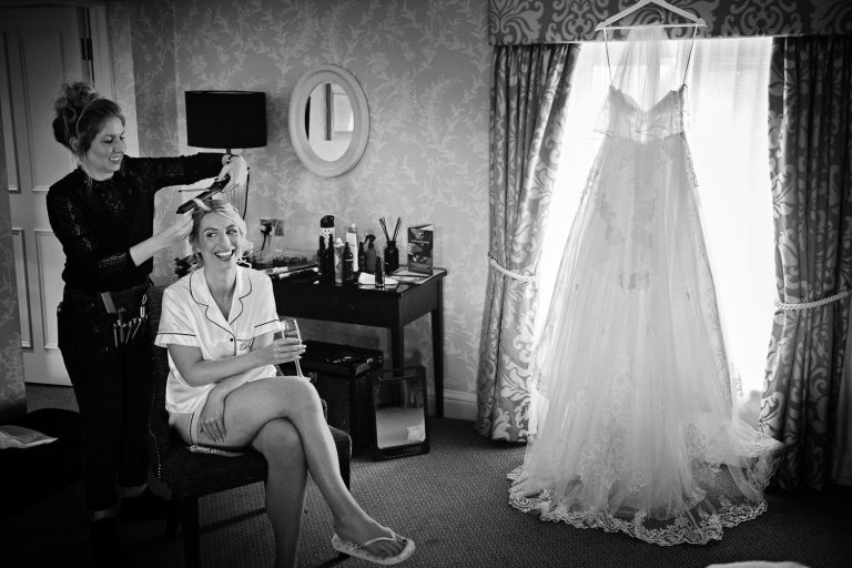 Documentary wedding photo of bride getting ready in the King Richard 111 room at Tewkesbury Park.