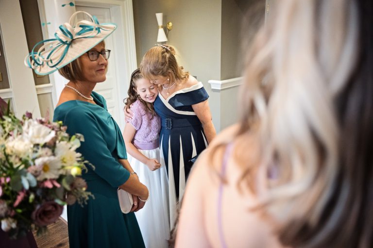 Candid, storytelling wedding photo of a nan giving a hug to her grandchild